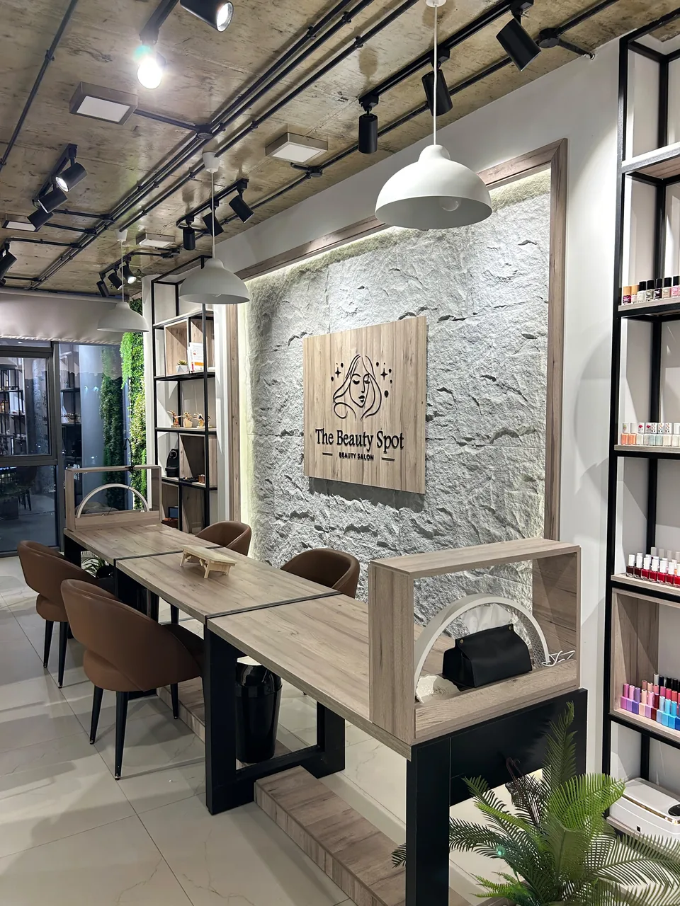 Warm wood and botanical nail area inside The Beauty Spot by Samah